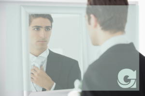 business man looking at himself in the mirror